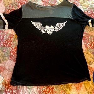 A black tee that has a heart with wings